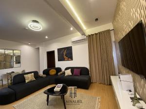 a living room with a couch and a table at Tainaliel Homes and Properties in Mama