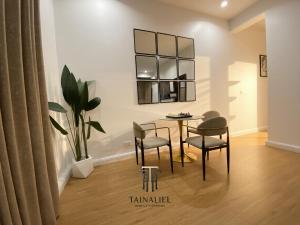 a dining room with a table and chairs and a plant at Tainaliel Homes and Properties in Mama