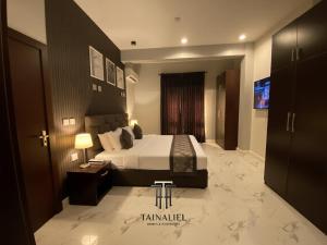 a bedroom with a bed and a television in it at Tainaliel Homes and Properties in Mama