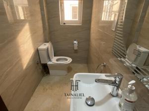 a bathroom with a white sink and a toilet at Tainaliel Homes and Properties in Mama +11 photos