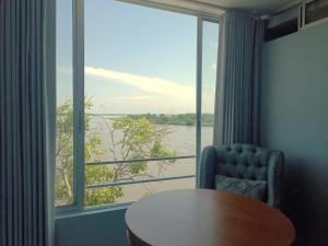 a room with a table and a large window at Panorama 1947 - Hotel Boutique Galería in El Banco