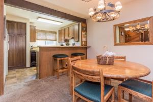 a kitchen with a wooden table and chairs at Mammoth Creek Unit 15 in Mammoth Lakes