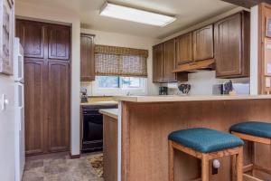 a kitchen with wooden cabinets and a counter top at Mammoth Creek Unit 15 in Mammoth Lakes