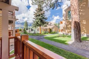 a home with a wooden fence and a yard at Mammoth Creek Unit 15 in Mammoth Lakes