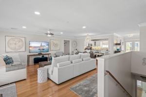a living room with a white couch and a table at Harbor On Holiday Isle in Destin
