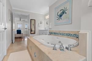 a large bathroom with a tub and a sink at Harbor On Holiday Isle in Destin