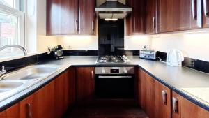 a kitchen with a sink and a stove top oven at Coral Shores - Part of the The Bay Filey Holiday Village with pool, gym and direct beach access, pub, restaurant, tennis and meadows walks in Filey