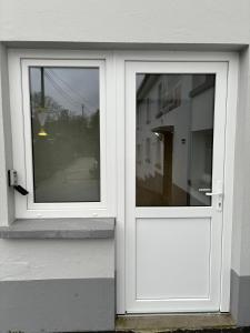 a white door on the side of a house at Studio Wangen in Burg-Reuland +2 photos