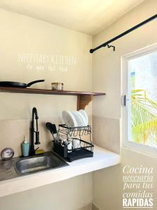 a kitchen counter with a sink and a window at Casa Roca II in Isla Mujeres +55 photos