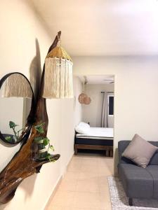 a living room with a couch and a mirror at Casa Roca II in Isla Mujeres