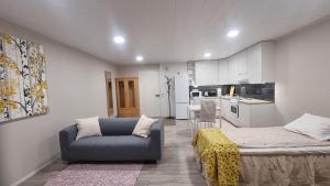 a room with a bed and a couch and a kitchen at Casa 48 in Lahti