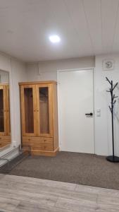 an empty room with a wooden door and a wall at Casa 48 in Lahti