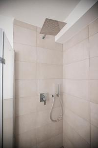 a bathroom with a shower with a shower head at Penthouse & Forest Retreat - near city in Bornheim +33 photos