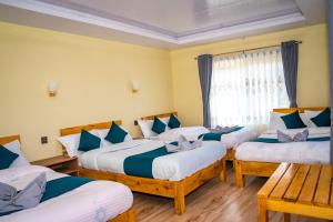 a group of four beds in a room at Chautari Hotel & Restaurant in Astam