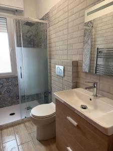 a bathroom with a toilet and a shower and a sink at AZZURRO LIDO ADRIANO VISTA MARE in Lido Adriano