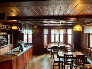 a dining room with tables and chairs in a restaurant at Hostinec Na hrázi in Hamr na Jezeře