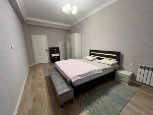 a bedroom with a large bed and a rug at Caspian Mirvari in Sumqayıt