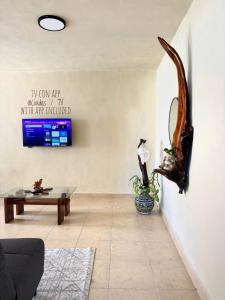 a living room with a couch and a table at Casa Roca II in Isla Mujeres