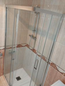 a shower with a glass door in a bathroom at Apartamento Maru's in Oropesa del Mar +16 photos
