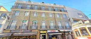 a large brick building with a balcony on top of it at Baixa GuestHouse in Lisbon