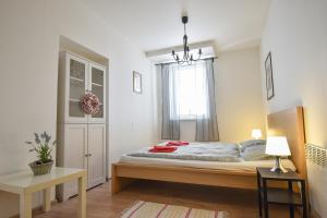 a bedroom with a bed and a window at Penzion Zacha se sklípkem in Vracov