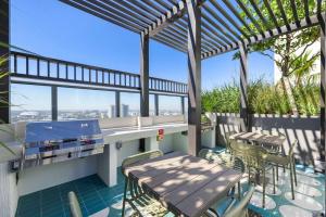 a patio with a table and chairs on a balcony at Luxury Studio Steps from Bayfrontpark in Miami