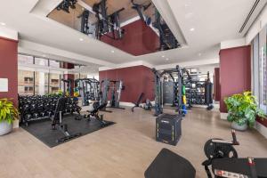 a gym with a lot of treadmills and machines at Luxury Studio Steps from Bayfrontpark in Miami