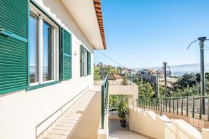 a balcony with a view of the ocean at Johns Villa by Homie in Canhas