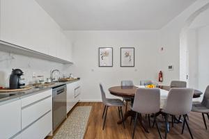 a kitchen and dining room with a table and chairs at Johns Villa by Homie in Canhas