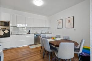 a kitchen and dining room with a table and chairs at Johns Villa by Homie in Canhas +38 photos
