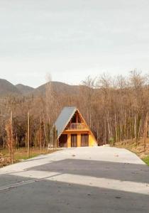 a barn with a road in front of it at vila pataraia in Martvili