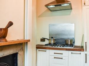 a kitchen with two pots on a stove at Market Place View in Knaresborough