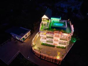 an overhead view of a building with a pool at night at Munnar Peak Paradise in Devikolam