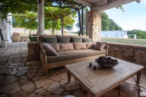 a couch sitting on a patio with a table at Tre Cercole - Eco Resort in San Marco in Lamis