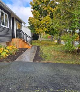 a driveway leading to a house with a tree at Calm on the Crescent in St. John's