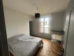 a small bedroom with a bed and a window at Chambre privee dans une maison 2 in Aulnay-sous-Bois +5 photos