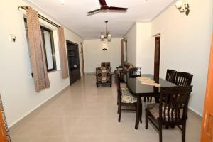 a dining room and living room with a table and chairs at Scandi-Stay 2BR by Benaulim Beach in Benaulim
