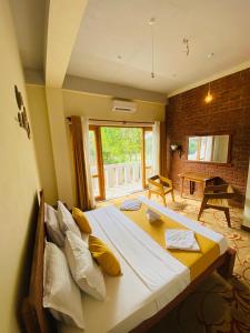 a bedroom with a large bed with yellow pillows at Lushy Glorious Hotel in Matara +72 photos