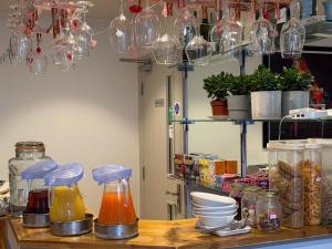 a kitchen counter with jars and dishes on a table at Oxford Guest House in Oxford