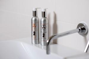 two bottles are sitting next to a bathroom sink at Tre Cercole - Eco Resort in San Marco in Lamis