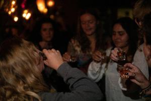a group of people drinking wine at a party at Oasis Backpackers' Hostel Granada in Granada
