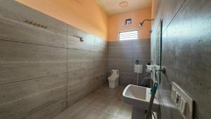 a bathroom with a sink and a toilet at The Green Retreat in Murthal