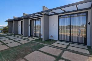 a rendering of a house with large windows at Chalés Brisas do Lago Capitólio in Capitólio