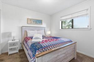 a white bedroom with a bed and a window at Coastal 2BR Condo w Ocean Views & Pool in Hilton Head Island +31 photos