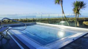 a swimming pool with a view of the ocean at The Waterside Hotel & Spa in Seamill
