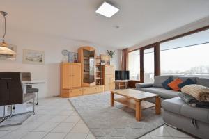 a living room with a couch and a table at FeWo Lange - Whg 48 in Kellenhusen