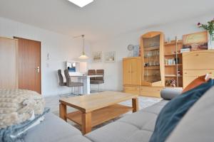 a living room with a couch and a table at FeWo Lange - Whg 48 in Kellenhusen