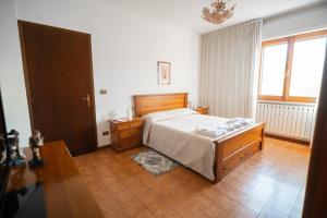 a bedroom with a bed and a table and a window at La madonnuccia in Deruta +20 photos
