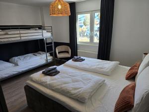 two beds in a dorm room with towels on them at Sauerland Apartments in Schwalefeld