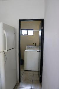 a door to a kitchen with a sink and a refrigerator at Departamentos Perfectamente ubicados con alberca in Ciudad Madero +22 photos